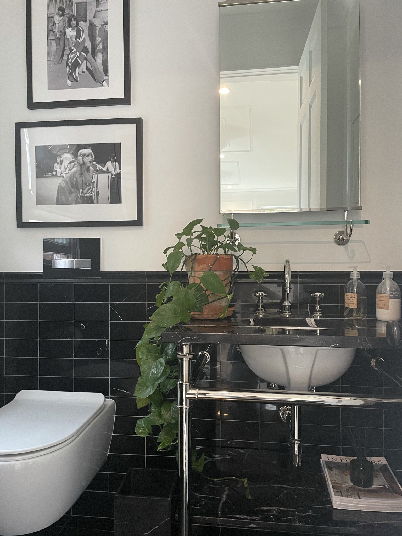 Black tile bathroom with rock photography