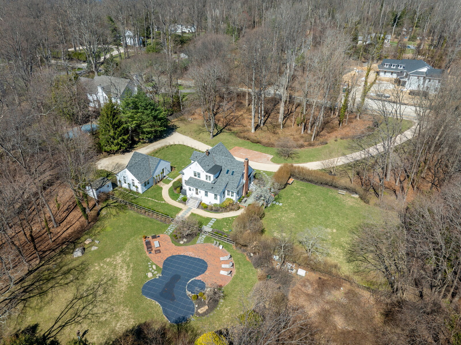Aerial view of property with pool and landscaped grounds