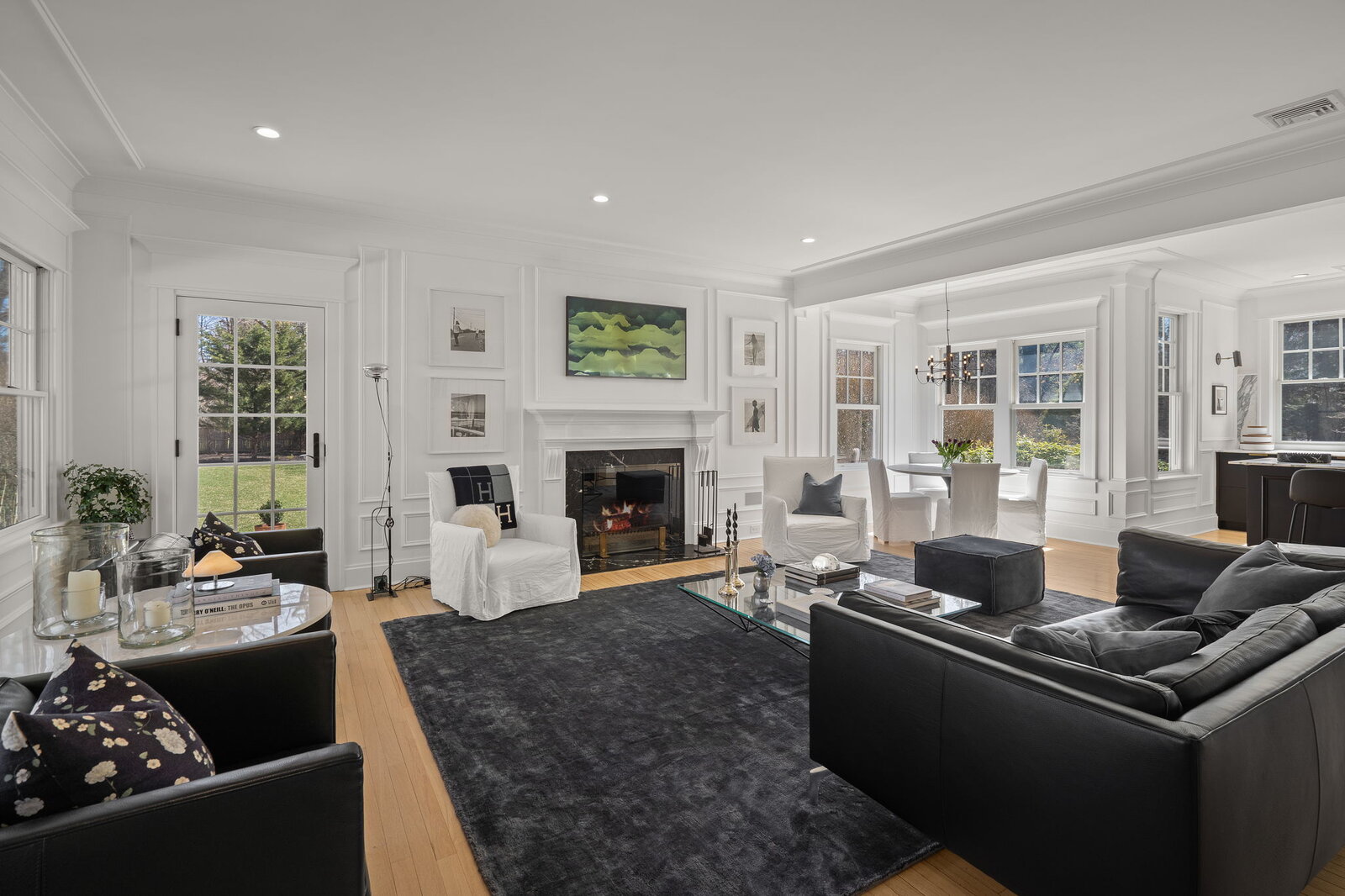 Living room with white paneling and fireplace